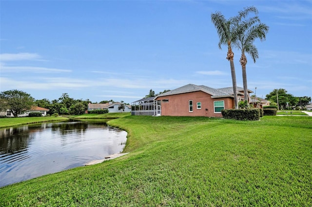 3612 Covington Dr, Holiday, FL 34691 - view of home's exterior with a water view, stucco siding, and a lawn