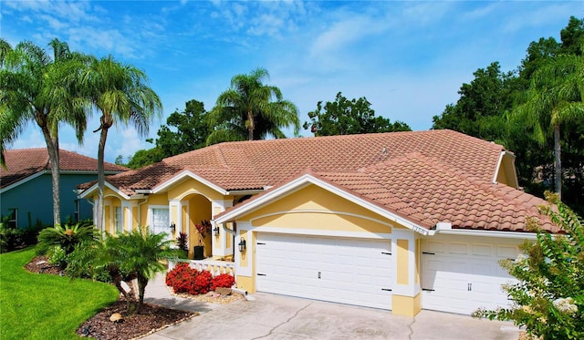 1358 Forestedge Blvd, Oldsmar, FL 34677 - mediterranean / spanish-style home with concrete driveway, stucco siding, an attached garage, and a tile roof