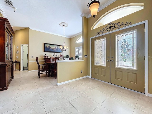 1358 Forestedge Blvd, Oldsmar, FL 34677 - foyer entrance featuring light tile patterned floors, ornamental molding, french doors, and a chandelier