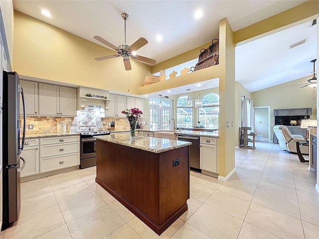 1358 Forestedge Blvd, Oldsmar, FL 34677 - kitchen with a ceiling fan, stainless steel appliances, tasteful backsplash, light tile patterned floors, and open floor plan