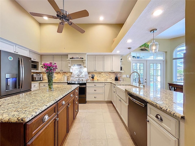 1358 Forestedge Blvd, Oldsmar, FL 34677 - kitchen featuring appliances with stainless steel finishes, open shelves, a ceiling fan, decorative backsplash, and a peninsula