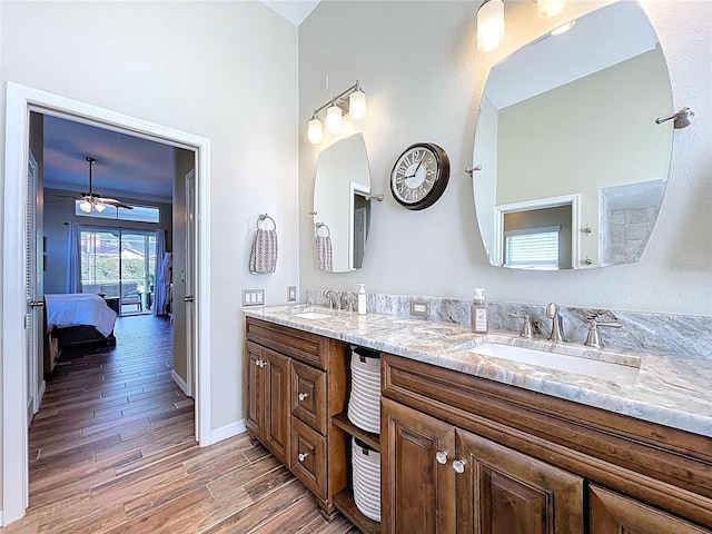 1358 Forestedge Blvd, Oldsmar, FL 34677 - bathroom with double vanity, wood finished floors, a ceiling fan, and ensuite bathroom