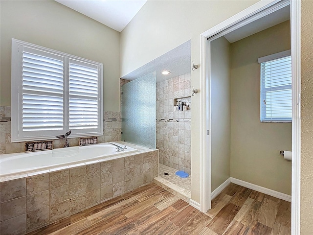 1358 Forestedge Blvd, Oldsmar, FL 34677 - full bath with a bath, wood finished floors, and healthy amount of natural light