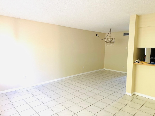 2525 W Bay Dr Unit A33, Largo, FL 33770 - spare room with a chandelier and a textured ceiling