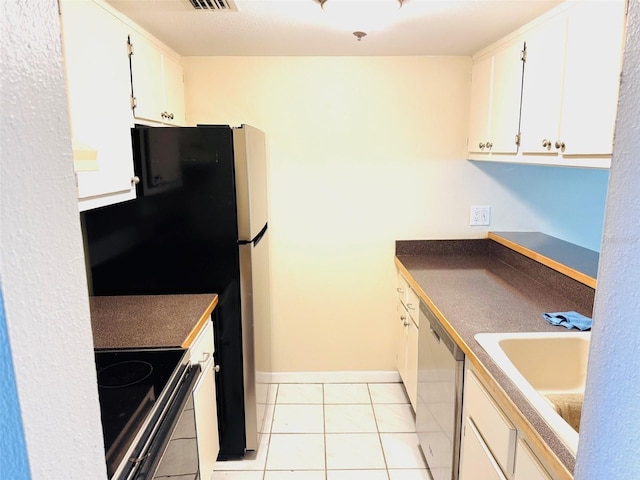 2525 W Bay Dr Unit A33, Largo, FL 33770 - kitchen with appliances with stainless steel finishes, light tile patterned floors, white cabinets, and dark countertops