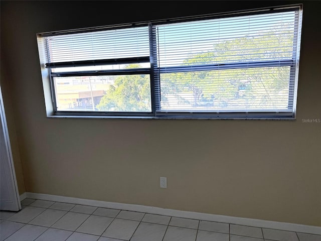 2525 W Bay Dr Unit A33, Largo, FL 33770 - unfurnished room featuring baseboards and light tile patterned floors