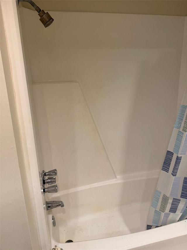 2525 W Bay Dr Unit A33, Largo, FL 33770 - full bathroom featuring shower / bathtub combination with curtain
