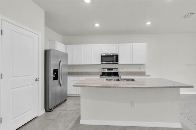 33036 Frosted Clover Way, Wesley Chapel, FL 33545 - kitchen featuring stainless steel appliances, white cabinetry, light tile patterned floors, light stone countertops, and recessed lighting