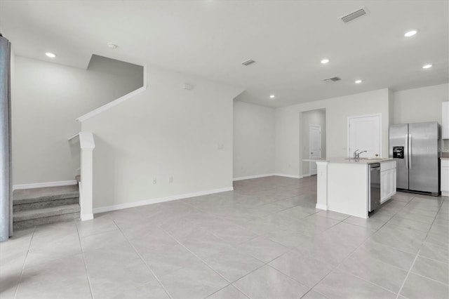 33036 Frosted Clover Way, Wesley Chapel, FL 33545 - kitchen featuring stainless steel appliances, open floor plan, light countertops, recessed lighting, and white cabinetry