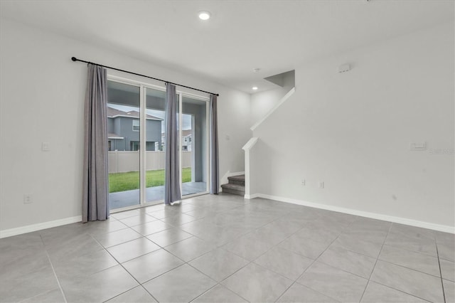 33036 Frosted Clover Way, Wesley Chapel, FL 33545 - spare room with stairway, light tile patterned flooring, and recessed lighting