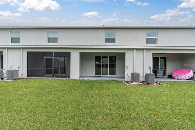 33036 Frosted Clover Way, Wesley Chapel, FL 33545 - rear view of house with stucco siding and a yard