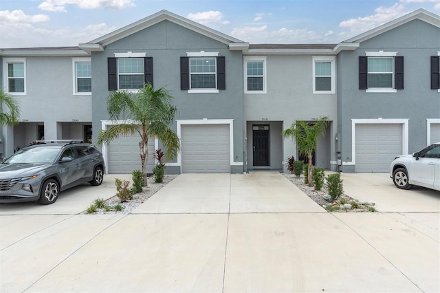 33036 Frosted Clover Way, Wesley Chapel, FL 33545 - townhome / multi-family property with driveway, a garage, and stucco siding