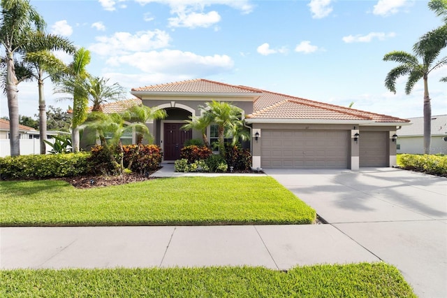 317 Royal Bonnet Dr, Apollo Beach, FL 33572 - mediterranean / spanish-style home with a tile roof, a garage, stucco siding, driveway, and a front yard