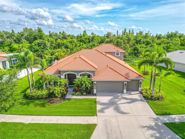 317 Royal Bonnet Dr, Apollo Beach, FL 33572 - mediterranean / spanish house with an attached garage, a tile roof, concrete driveway, and a front lawn