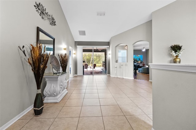 317 Royal Bonnet Dr, Apollo Beach, FL 33572 - foyer with arched walkways, light tile patterned flooring, and lofted ceiling