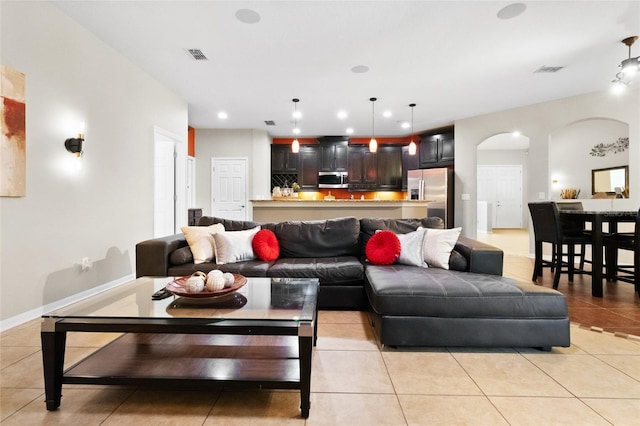 317 Royal Bonnet Dr, Apollo Beach, FL 33572 - living area with light tile patterned flooring, arched walkways, and recessed lighting
