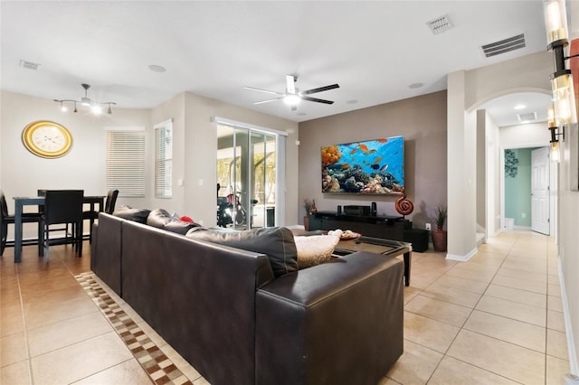 317 Royal Bonnet Dr, Apollo Beach, FL 33572 - living room with light tile patterned floors, arched walkways, and ceiling fan