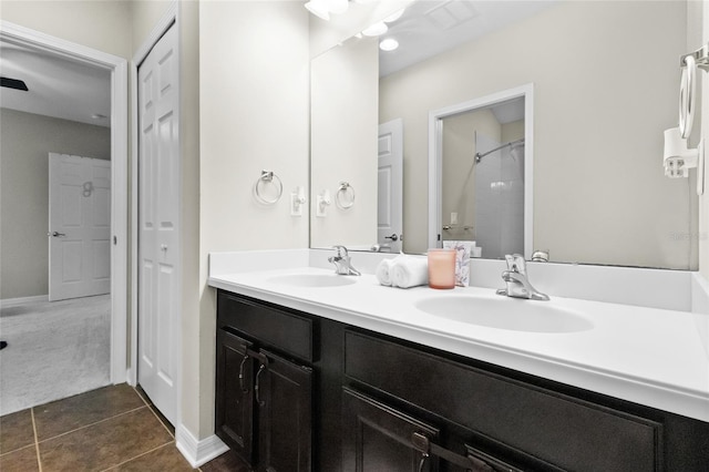 317 Royal Bonnet Dr, Apollo Beach, FL 33572 - bathroom with double vanity, a shower, tile patterned floors, and a closet