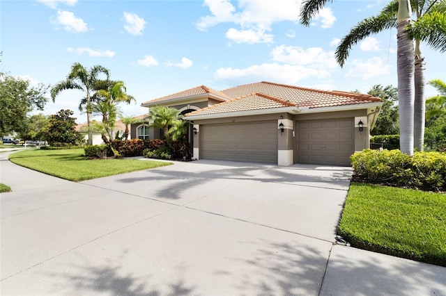 317 Royal Bonnet Dr, Apollo Beach, FL 33572 - mediterranean / spanish-style home featuring stucco siding, an attached garage, driveway, a front lawn, and a tiled roof