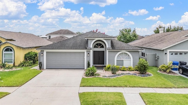 2208 Cattleman Dr, Brandon, FL 33511 - view of front facade with an attached garage, stucco siding, driveway, roof with shingles, and a front yard