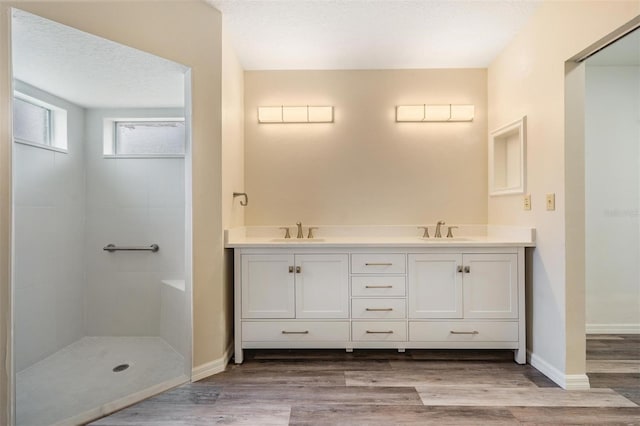 2208 Cattleman Dr, Brandon, FL 33511 - bathroom with wood finished floors, double vanity, and tiled shower