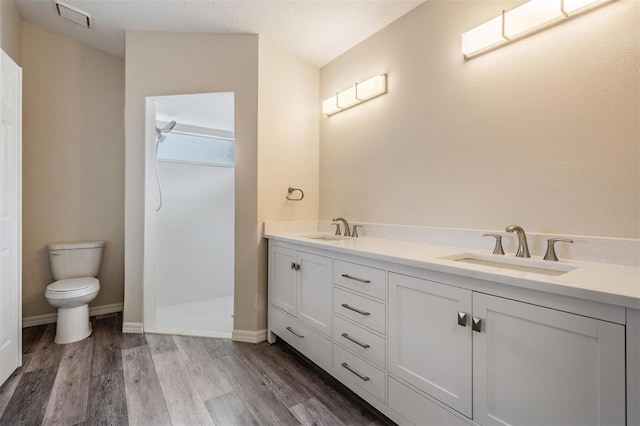 2208 Cattleman Dr, Brandon, FL 33511 - full bath with double vanity, a walk in shower, and wood finished floors