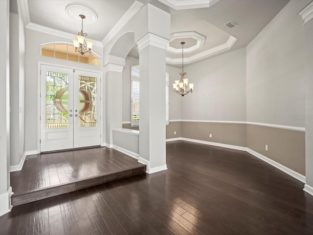 4521 Cheval Blvd, Lutz, FL 33558 - foyer entrance featuring a chandelier, french doors, arched walkways, wood-type flooring, and crown molding