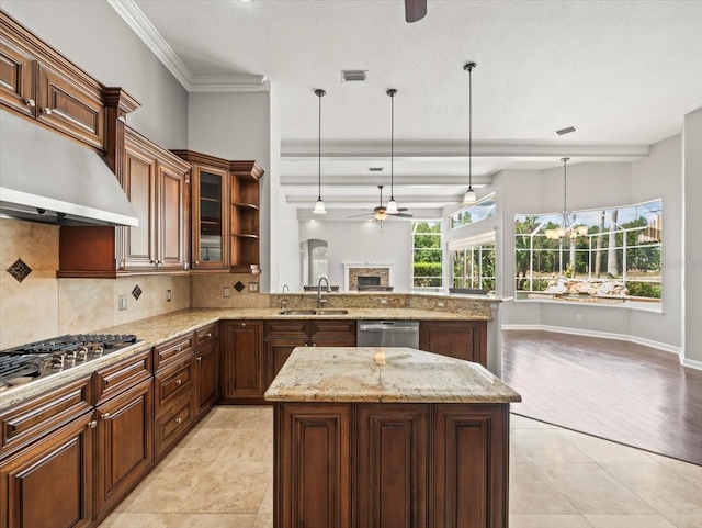 4521 Cheval Blvd, Lutz, FL 33558 - kitchen featuring ceiling fan, range hood, tasteful backsplash, open floor plan, and decorative light fixtures