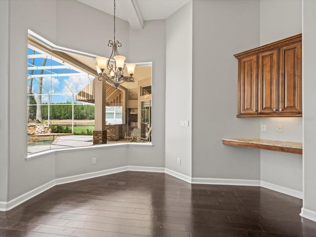 4521 Cheval Blvd, Lutz, FL 33558 - unfurnished dining area featuring dark wood finished floors, a chandelier, and a high ceiling