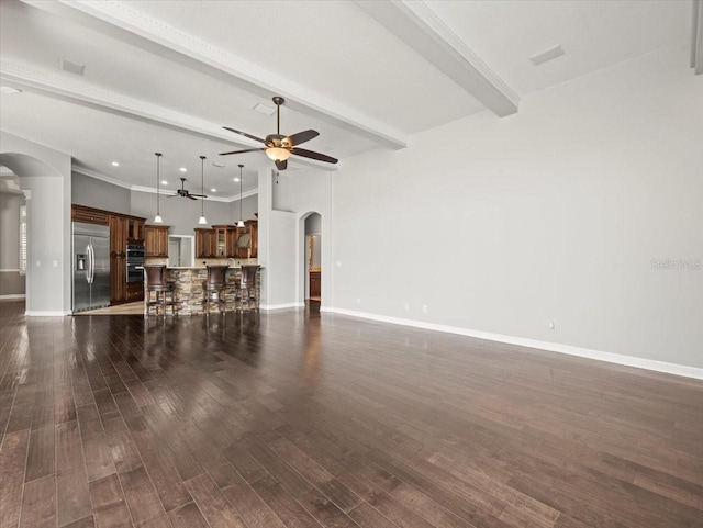 4521 Cheval Blvd, Lutz, FL 33558 - unfurnished living room with arched walkways, a ceiling fan, beam ceiling, and dark wood finished floors