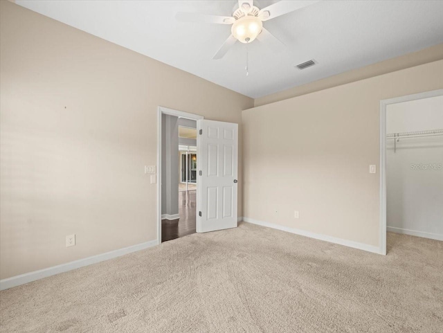 4521 Cheval Blvd, Lutz, FL 33558 - unfurnished bedroom with carpet, a walk in closet, a closet, and a ceiling fan