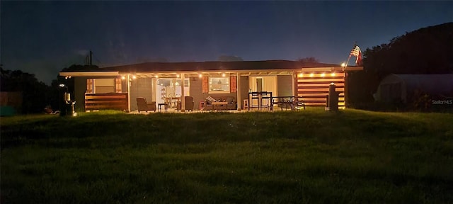 4119 Chambers St, Lake Wales, FL 33898 - back of house at twilight featuring a lawn