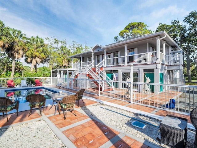 4915 S Rd, New Port Richey, FL 34652 - back of property with stairway and a patio