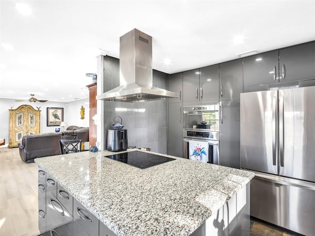 4915 S Rd, New Port Richey, FL 34652 - kitchen featuring stainless steel appliances, extractor fan, gray cabinets, light stone counters, and modern cabinets