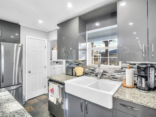4915 S Rd, New Port Richey, FL 34652 - kitchen featuring appliances with stainless steel finishes, washer and clothes dryer, gray cabinetry, modern cabinets, and recessed lighting