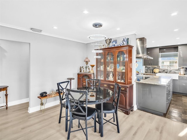 4915 S Rd, New Port Richey, FL 34652 - dining space with ornamental molding, light wood-style flooring, and recessed lighting