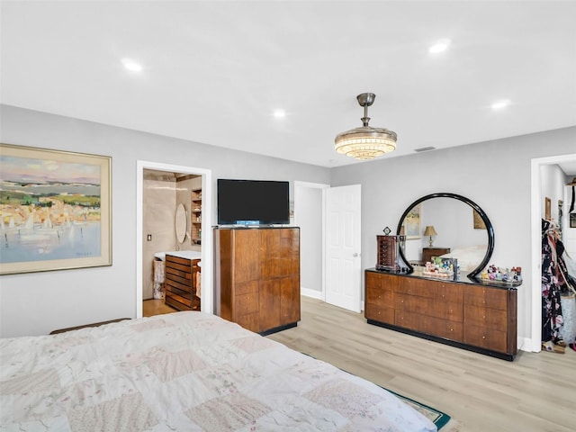 4915 S Rd, New Port Richey, FL 34652 - bedroom with light wood-style flooring, recessed lighting, and ensuite bathroom