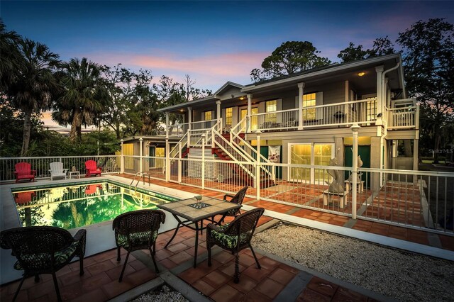4915 S Rd, New Port Richey, FL 34652 - back of property featuring stairway, a patio, and a balcony