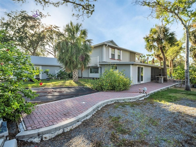 4915 S Rd, New Port Richey, FL 34652 - rear view of house featuring stucco siding and a patio area