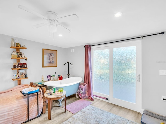 4915 S Rd, New Port Richey, FL 34652 - bathroom featuring a soaking tub, ceiling fan, wood finished floors, and recessed lighting