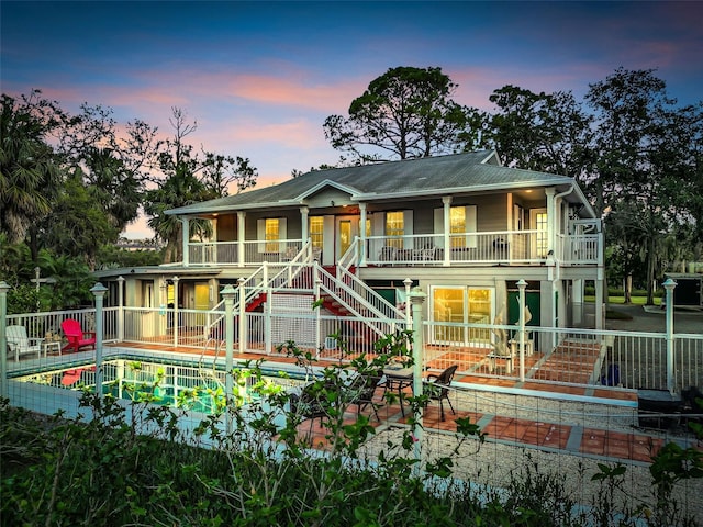4915 S Rd, New Port Richey, FL 34652 - back of property featuring stairs, a patio area, and covered porch