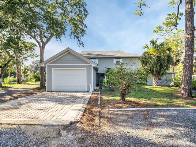 4915 S Rd, New Port Richey, FL 34652 - view of front facade with a garage and decorative driveway