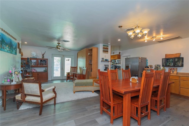 33 Cypress Dr, Palm Harbor, FL 34684 - dining room with wood finished floors, a chandelier, french doors, ceiling fan, and recessed lighting