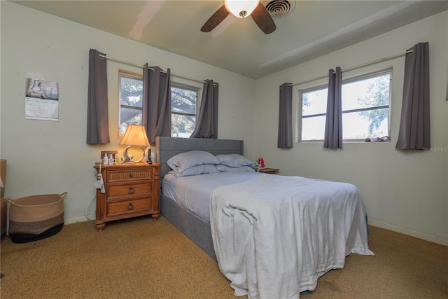 33 Cypress Dr, Palm Harbor, FL 34684 - bedroom with carpet flooring, multiple windows, and ceiling fan