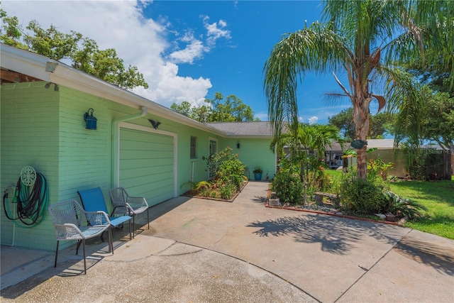 33 Cypress Dr, Palm Harbor, FL 34684 - view of patio / terrace with driveway and an attached garage