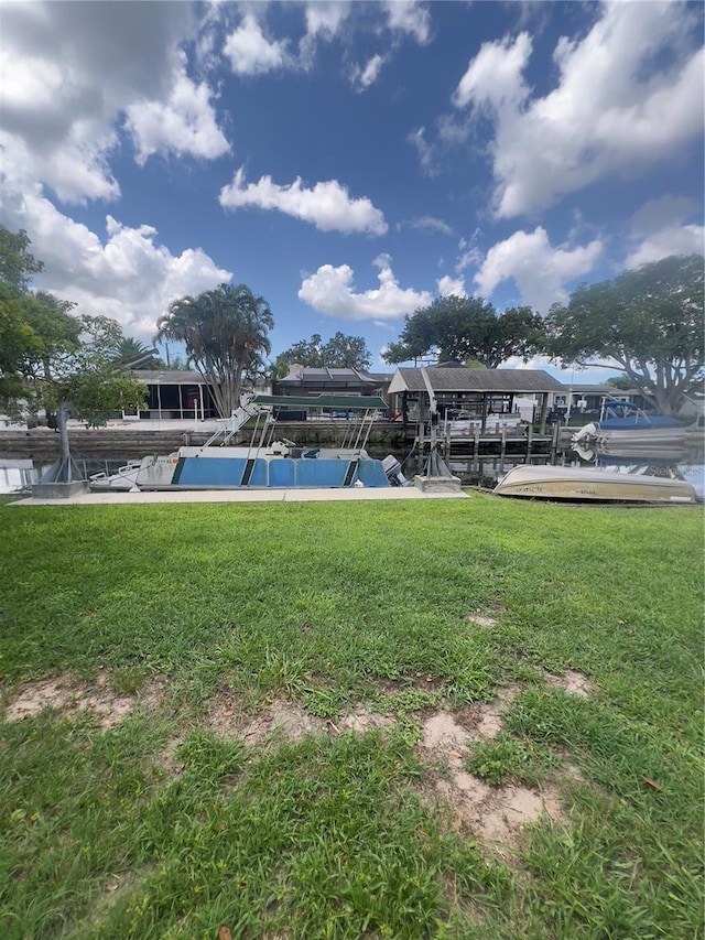 33 Cypress Dr, Palm Harbor, FL 34684 - dock with boat lift and a yard