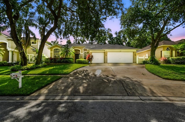 2009 Raven Manor Dr, Dover, FL 33527 - ranch-style home featuring a garage, a lawn, concrete driveway, and stucco siding