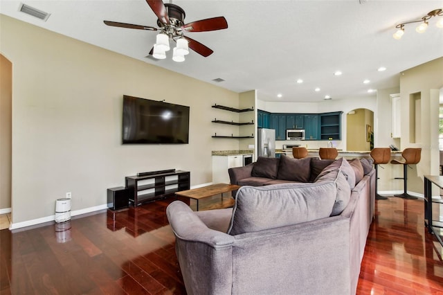 2009 Raven Manor Dr, Dover, FL 33527 - living area with arched walkways, dark wood-style flooring, a ceiling fan, and recessed lighting