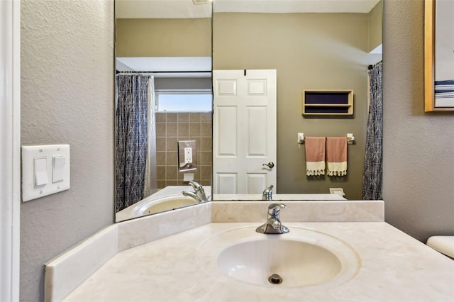 2009 Raven Manor Dr, Dover, FL 33527 - full bath with vanity, a textured wall, and a shower with shower curtain