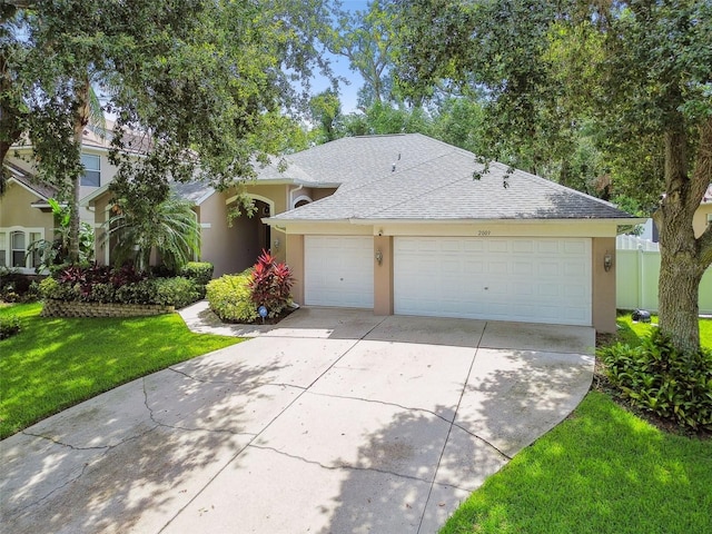 2009 Raven Manor Dr, Dover, FL 33527 - view of front of home featuring stucco siding, a shingled roof, concrete driveway, and a garage